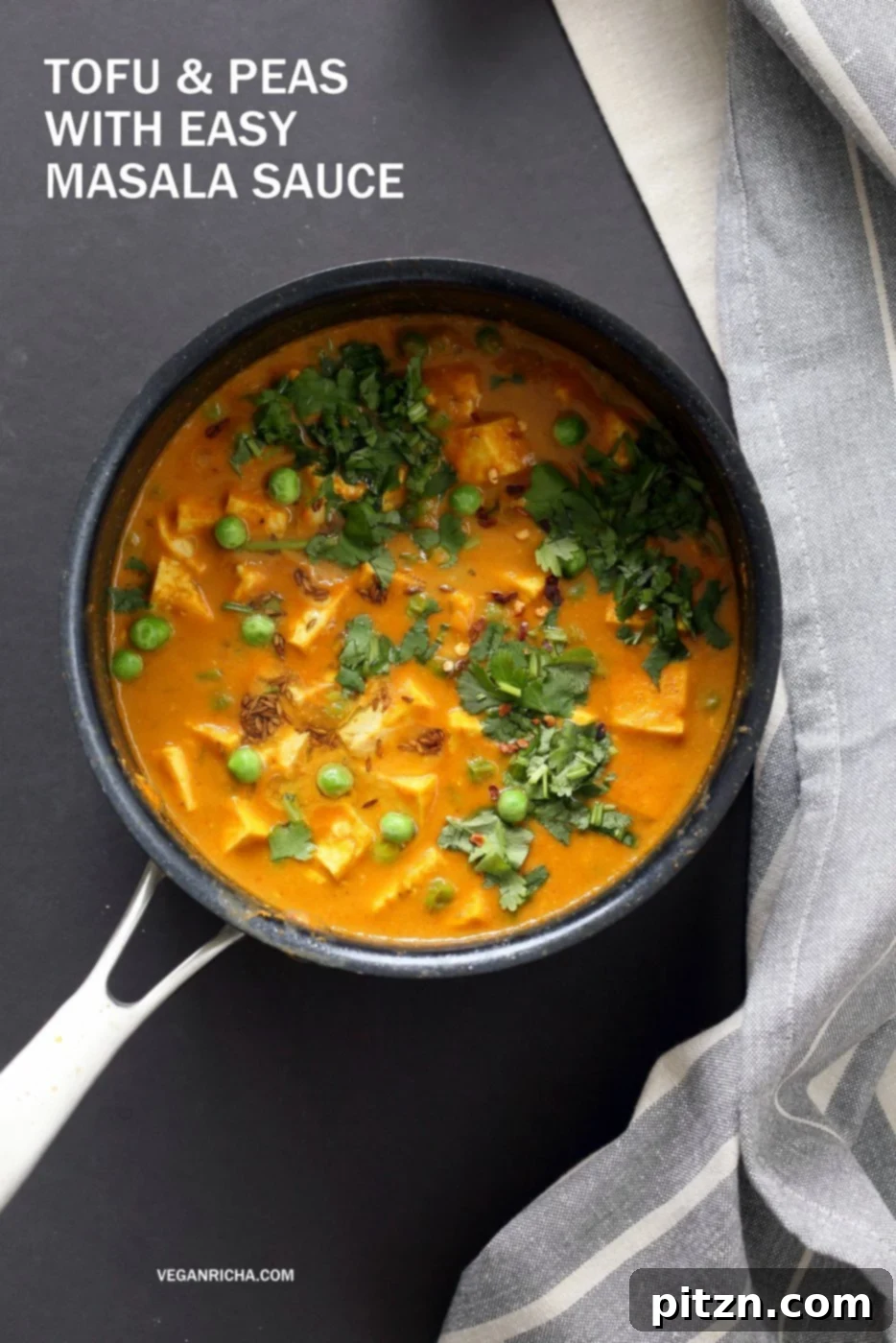 Tofu Peas Curry in a black saucepan garnished with toasted cumin, Indian Tofu Matar Masala