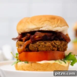 side view if vegan chickpea burger with caramelized onions and hummus