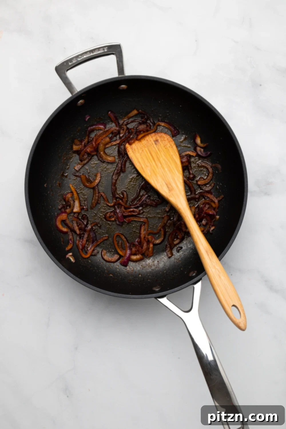 chickpea burger overhead shot of caramelized onion in a black frying pan
