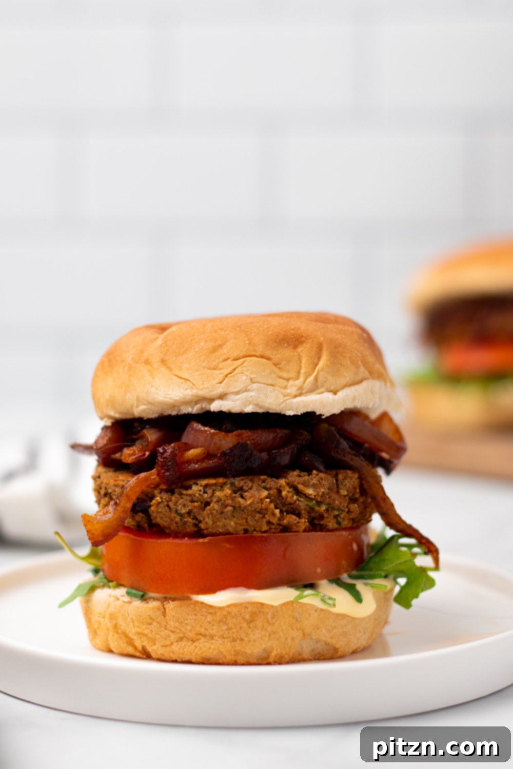 chickpea burger side view of a vegan Middle Eastern Za'atar Spiced Chickpea Burger on a white plate