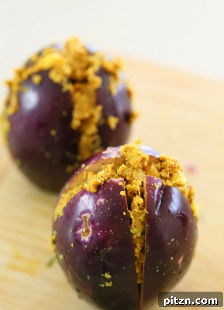 Instant Pot Masala Eggplant Curry: Stuffed baby eggplants prepared using pressure cooking for a quick and flavorful Indian dish.