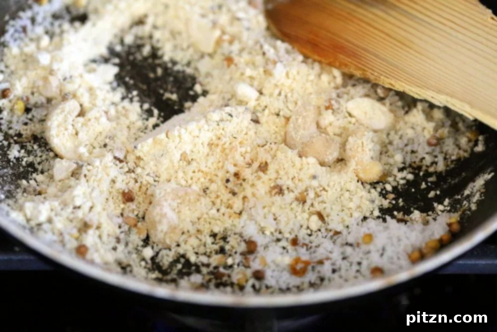 Toasting chickpea flour, nuts, and coconut to create a fragrant base for the stuffed eggplant masala.