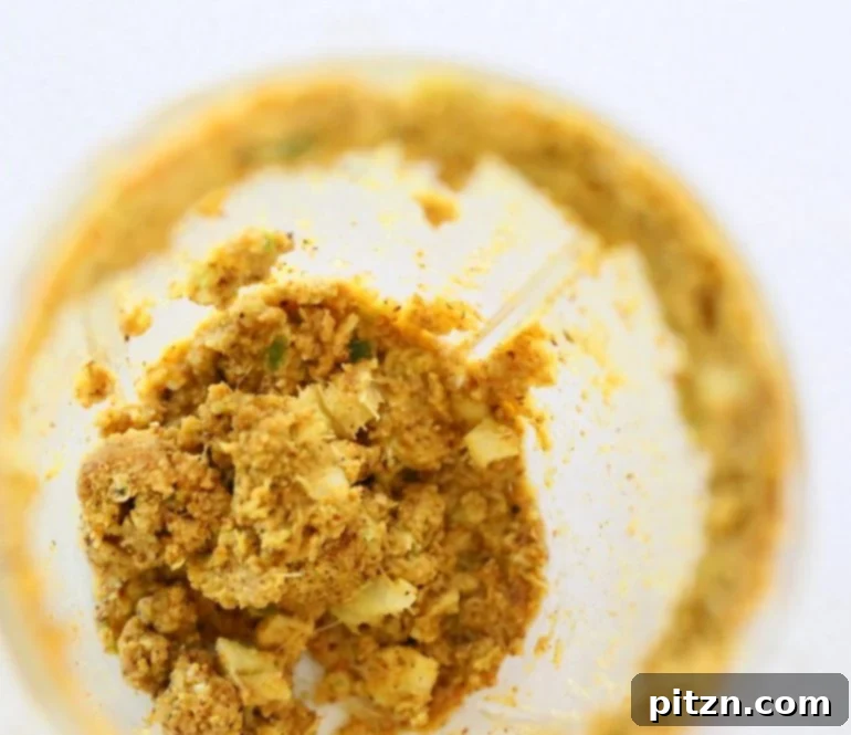 Blending toasted spices, ginger, garlic, and lime juice into a coarse paste for the eggplant stuffing.