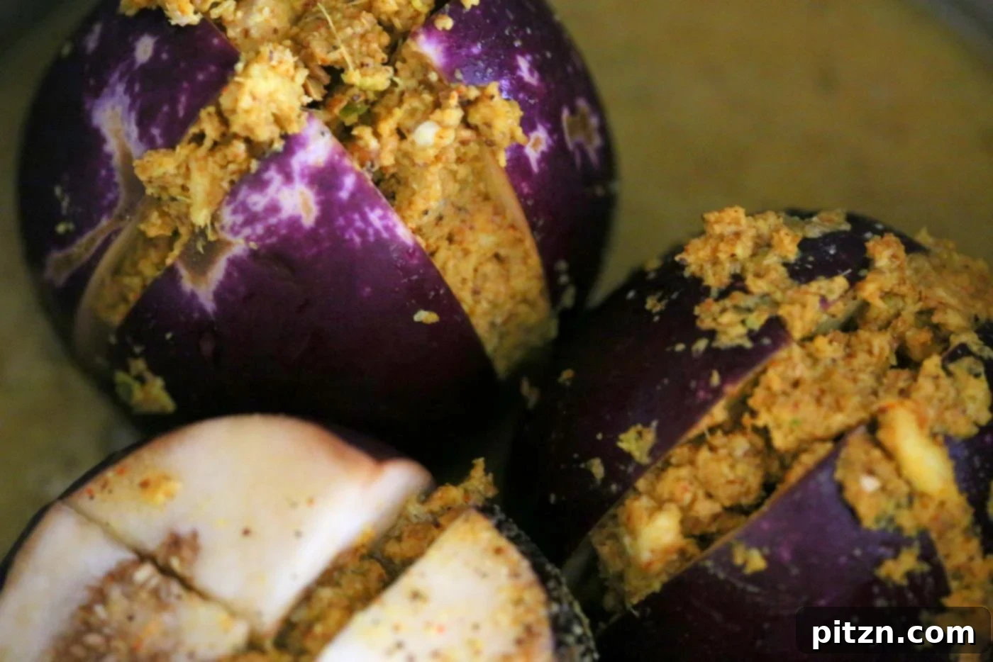 Stuffed eggplants ready in the Instant Pot with water, prepared for quick and efficient pressure cooking.