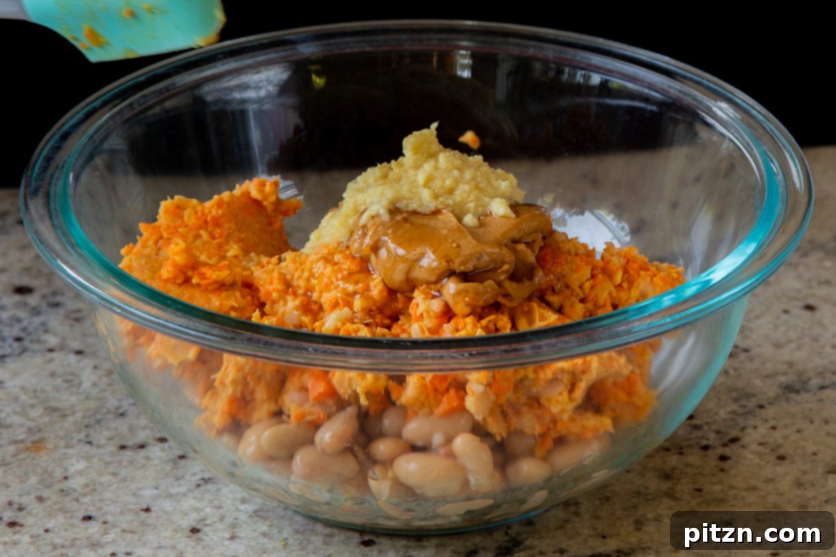 Hearty Peanut Carrot White Bean Burgers 9 Step 4: The pulsed burger mixture transferred to a bowl, with remaining dry and wet ingredients added.