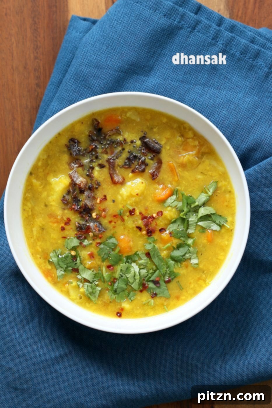Lentil Veggie Dhansak, a Parsi Indian dish, with a vibrant mix of dal and vegetables, ideal for a vegan and gluten-free diet. Served with rice or flatbread. VeganRicha.com
