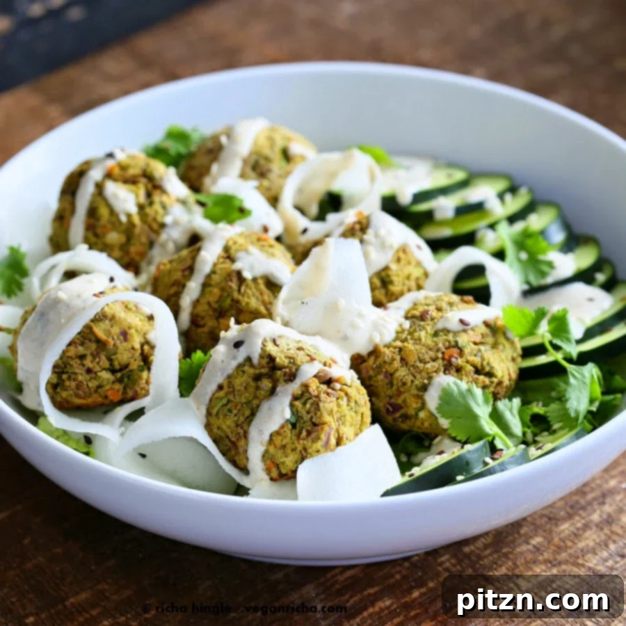 Close-up of baked lentil falafels in a serving bowl with fresh vegetables