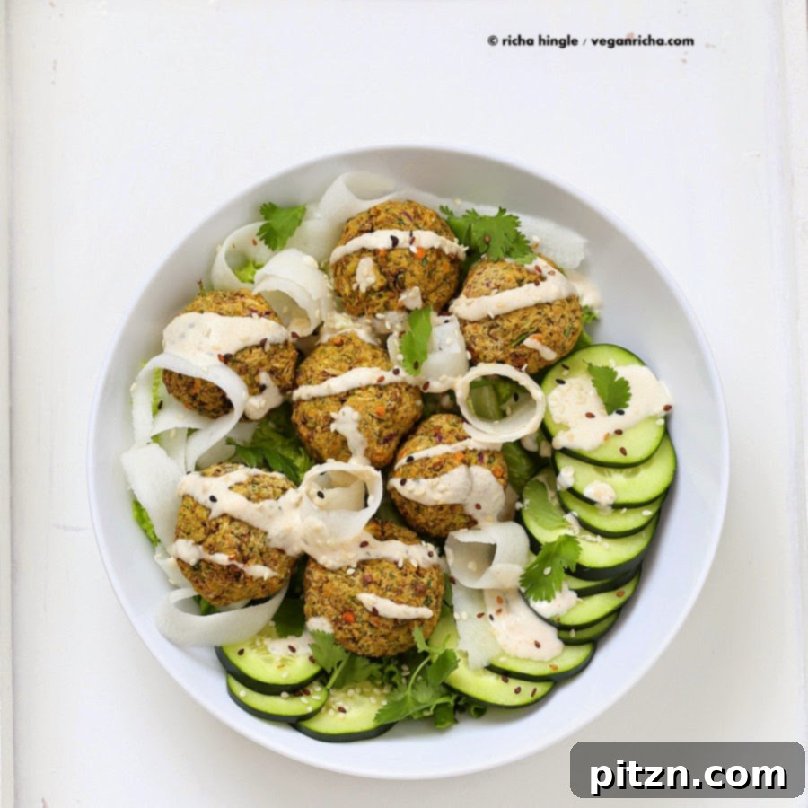 Falafel bowl with various fresh ingredients and tahini sauce