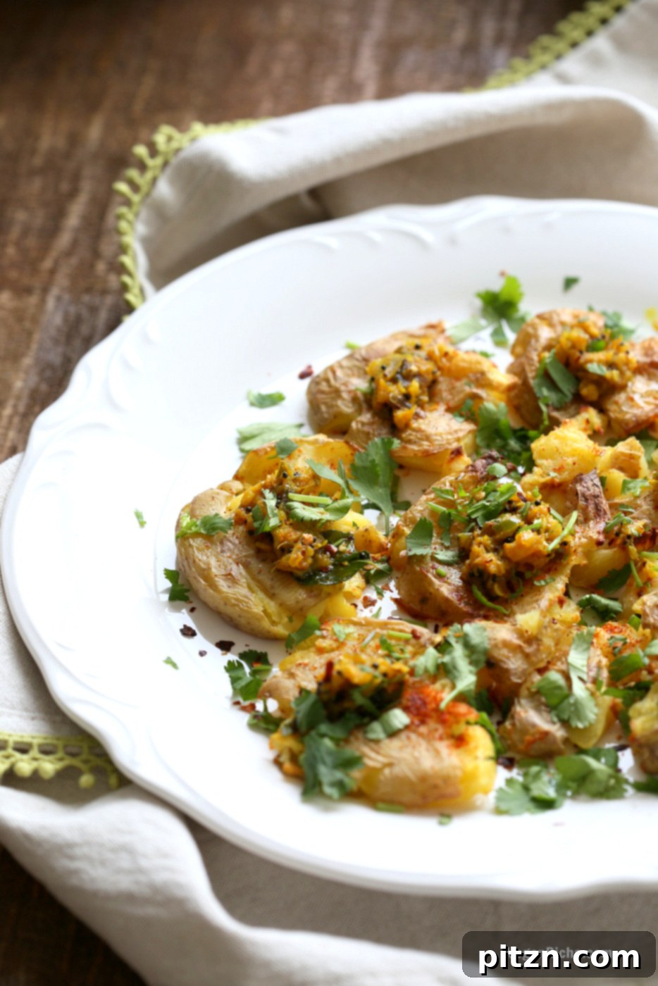 Spiced Smashed Potatoes with a Mustard Ginger Infusion 11 A final close-up of the finished Indian Spiced Smashed Potatoes, beautifully garnished with fresh cilantro, ready to be enjoyed as a flavorful and healthy snack.