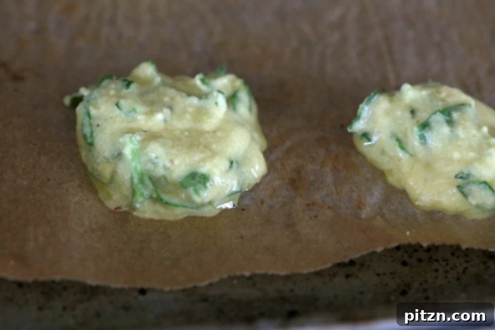 Overhead view of a spread of Mung Dal Fritters with fresh herbs and spices.
