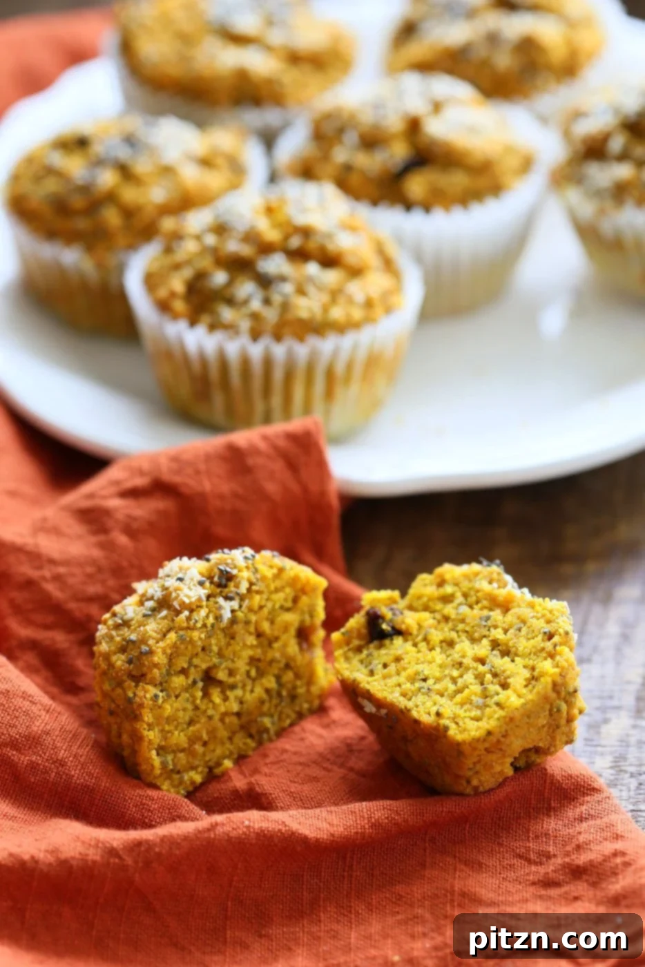 Beautifully baked Vegan Turmeric Carrot Muffins, golden and soft, on a white plate, showcasing their delightful texture and inviting appearance. A perfect healthy and flavorful plant-based breakfast or snack from VeganRicha.com