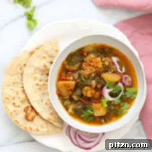 Instant Pot Aloo Palak Dal Delicious Spiced Potato Spinach Lentils 5 Aloo Palak Dal served in a bowl, garnished with fresh cilantro.