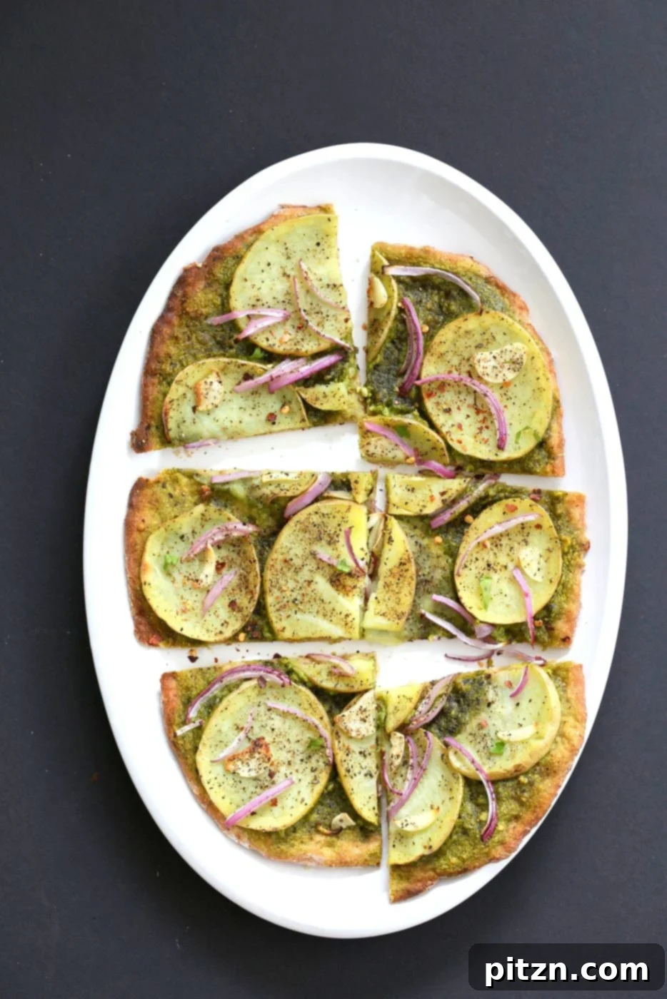 Vegan Basil Spinach Potato Pesto Pizza 7 Close-up of the Easy Potato Pesto Pizza, showcasing its thin, crispy crust, vibrant pesto, and perfectly cooked potato slices after baking.