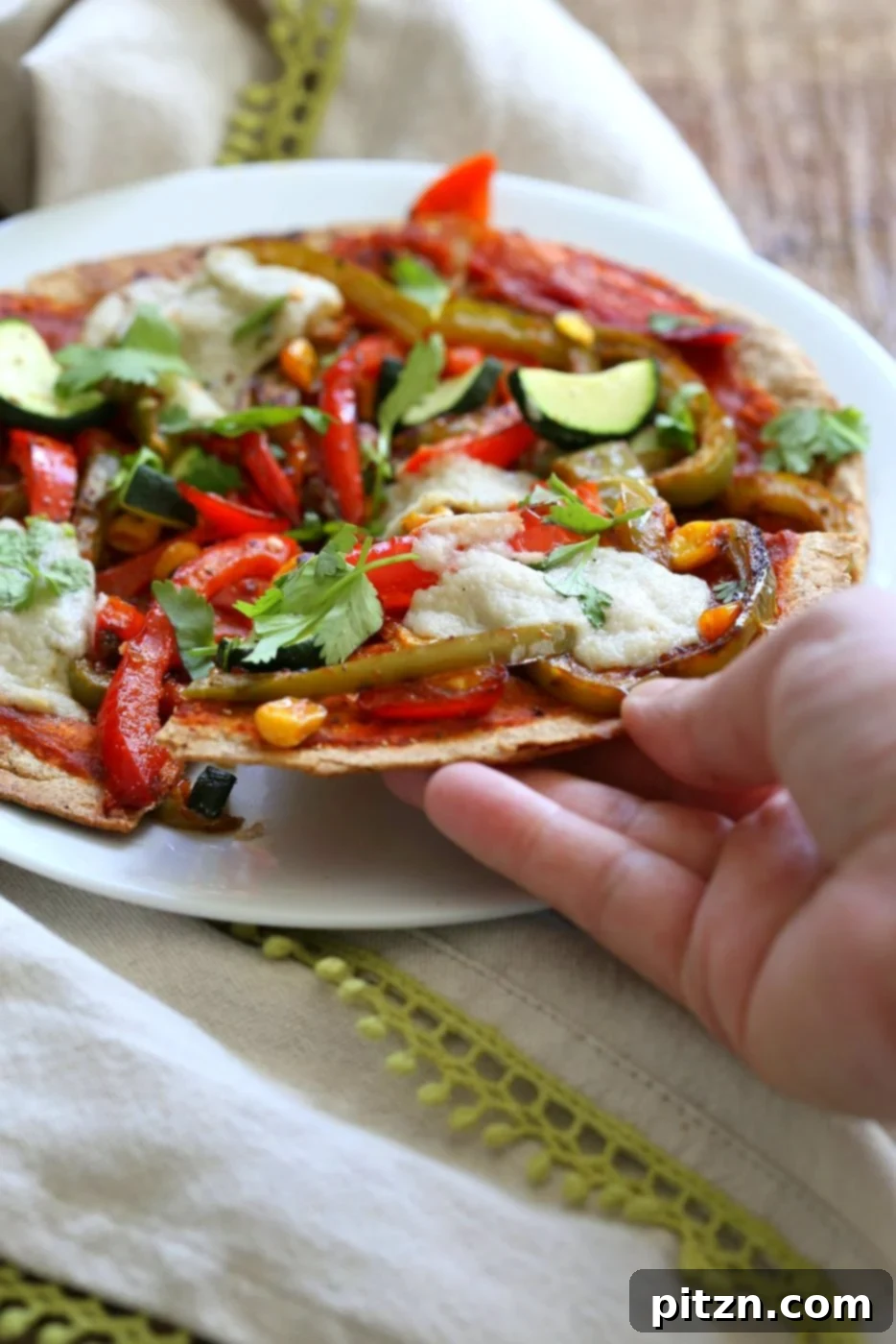 Close-up of Fajita Veggies before baking, showcasing colorful bell peppers, corn, and onions seasoned with smoky fajita spices. Perfect for a vegan tortilla pizza or tacos.
