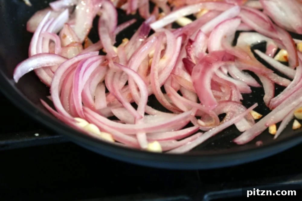 Cooking onion and garlic for Vegan Barbacoa Mushroom Tacos