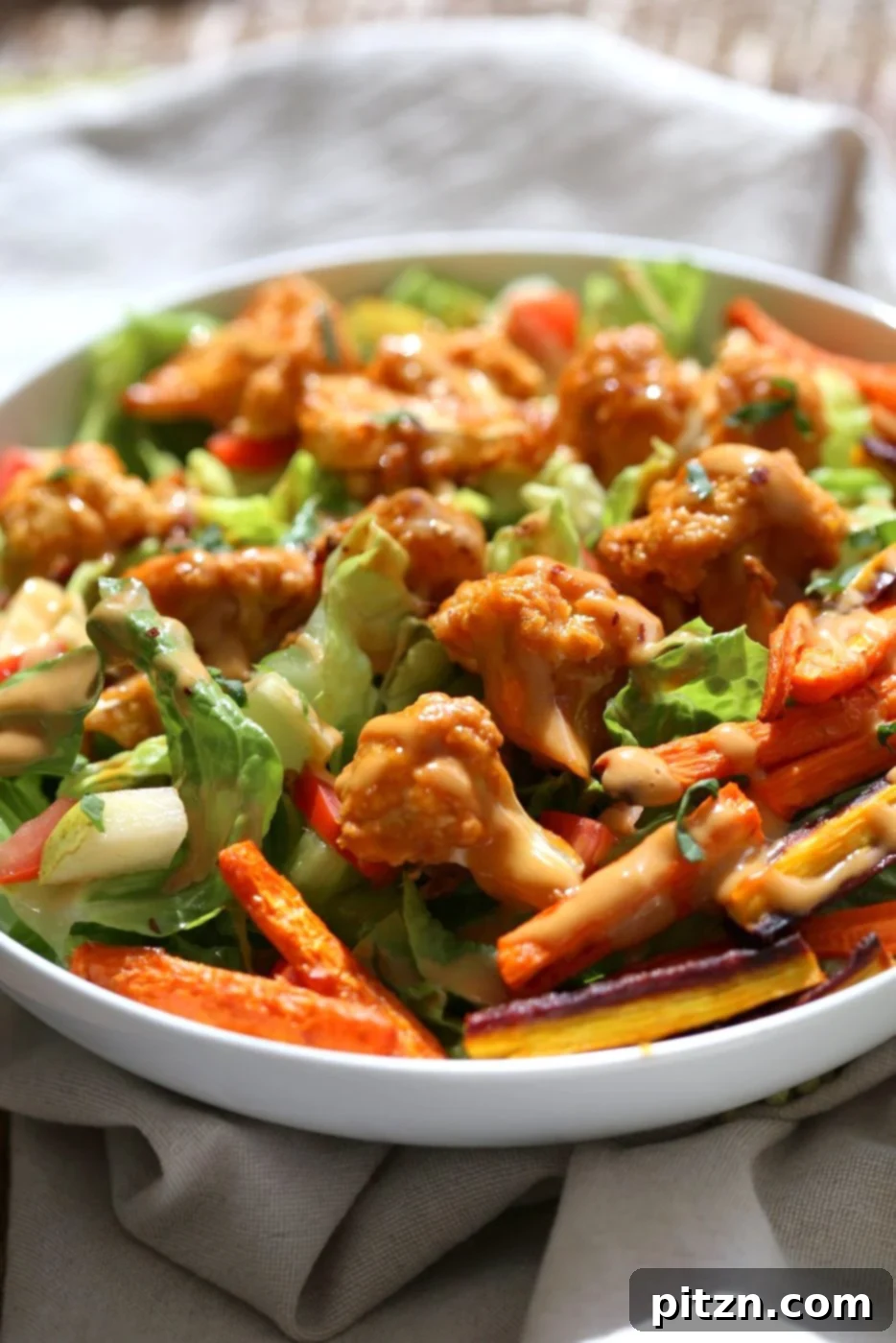 The final spread of the Peanut Butter Cauliflower and Carrot Bowl, complete with fresh garnishes and a generous drizzle of sauce, captured to showcase its inviting appeal. This is the perfect ending to a wholesome, vegan, and gluten-free meal.