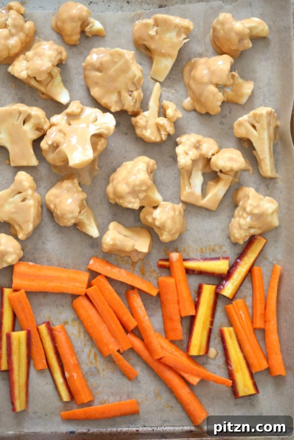 Another perspective of the Peanut Butter Cauliflower and Carrot Bowl, showing the generous portions of peanut-coated cauliflower and spicy roasted carrots, ready to be enjoyed. A perfect illustration of a satisfying plant-based meal.
