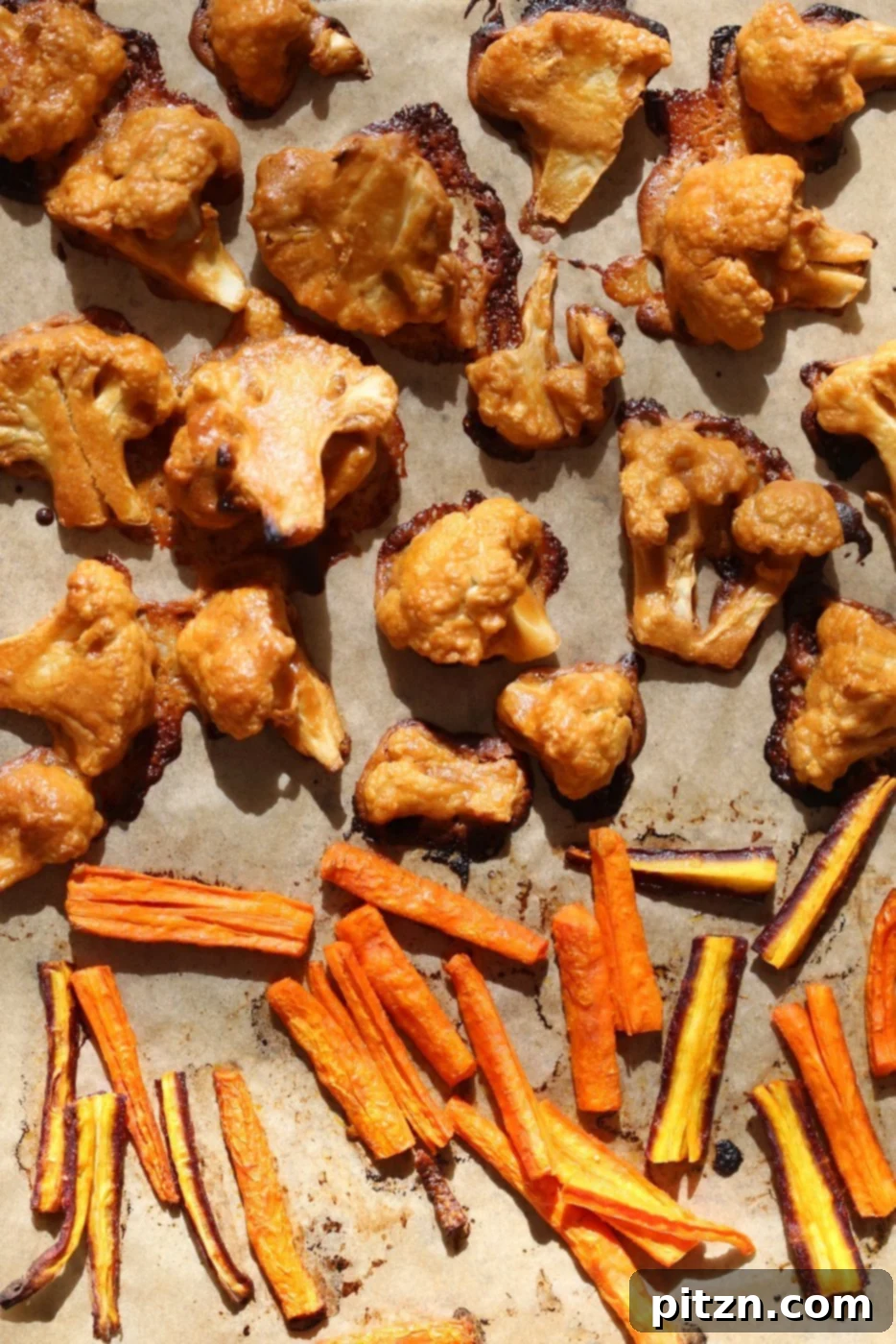 Delicious close-up of roasted peanut butter cauliflower, showing the rich, caramelized sauce and tender texture. A key component of the healthy, vegan, and gluten-free Peanut Butter Cauliflower and Carrot Bowl.