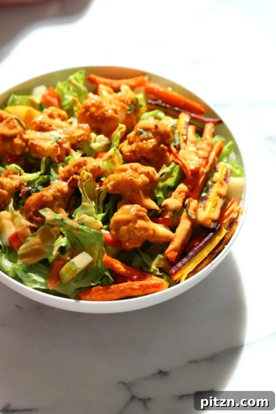 Another angle of the roasted peanut butter cauliflower, emphasizing the perfect golden-brown color and the appealing coating of the sauce. This detail shot highlights the care taken in preparing this wholesome vegan dish.
