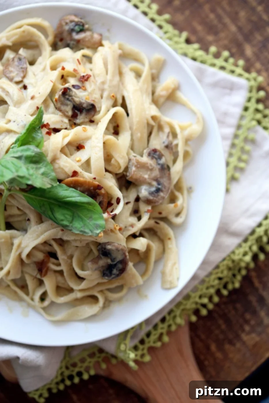 Velvet Vegan Mushroom Alfredo Fettuccine 9 A beautifully plated dish of Vegan Mushroom Garlic Alfredo, showcasing its rich texture and appetizing appeal.