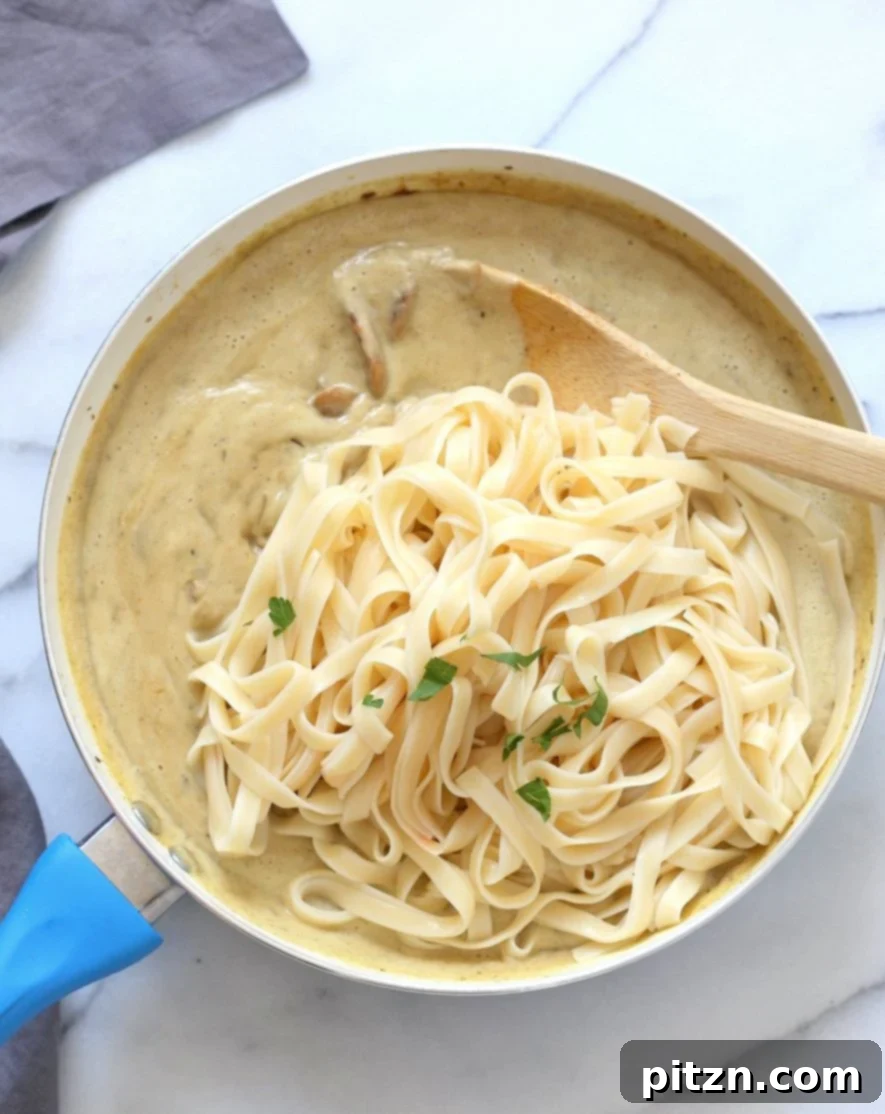 Velvet Vegan Mushroom Alfredo Fettuccine 5 Adding wine and vegan Worcestershire sauce to browned mushrooms, then incorporating the blended creamy alfredo sauce.
