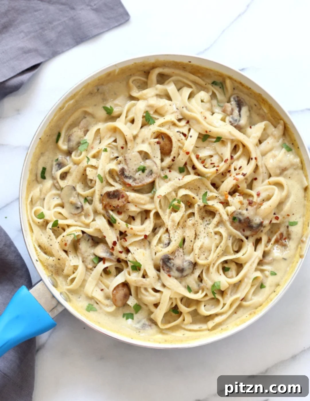 Velvet Vegan Mushroom Alfredo Fettuccine 7 Close-up of a serving of vegan mushroom garlic fettuccine alfredo, ready to be enjoyed.