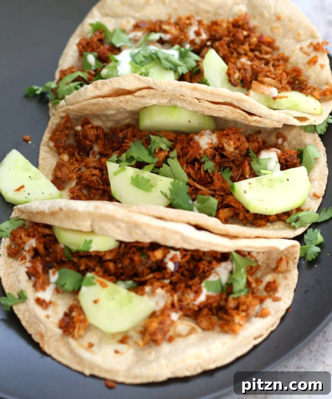 Berbere Spiced Jackfruit Tacos 9 A beautifully arranged serving of Berbere Spiced Jackfruit Tacos, inviting and colorful, on a rustic background.