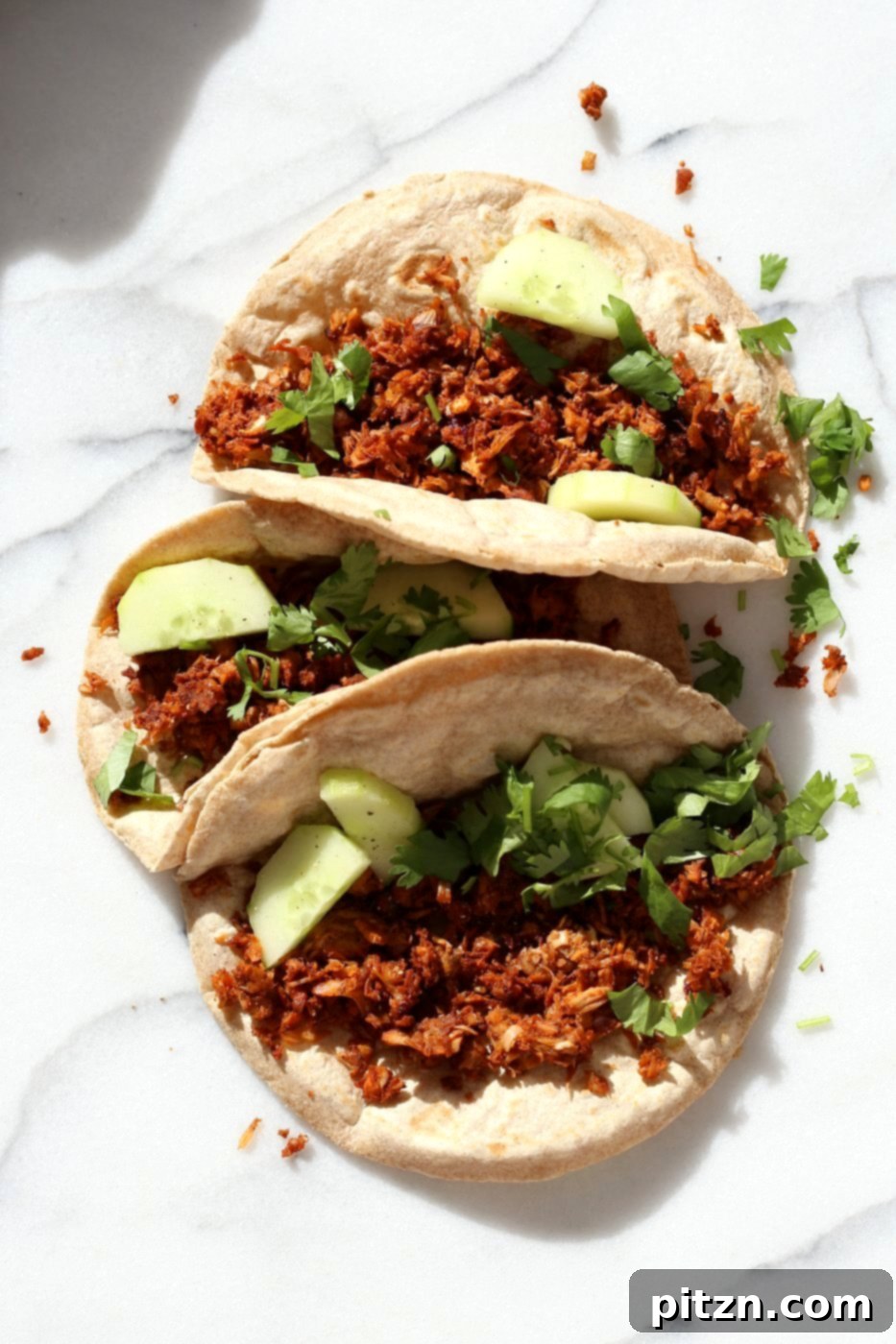 Berbere Spiced Jackfruit Tacos 6 A beautifully presented Berbere Spiced Jackfruit Taco, showcasing its appealing filling and fresh garnishes.