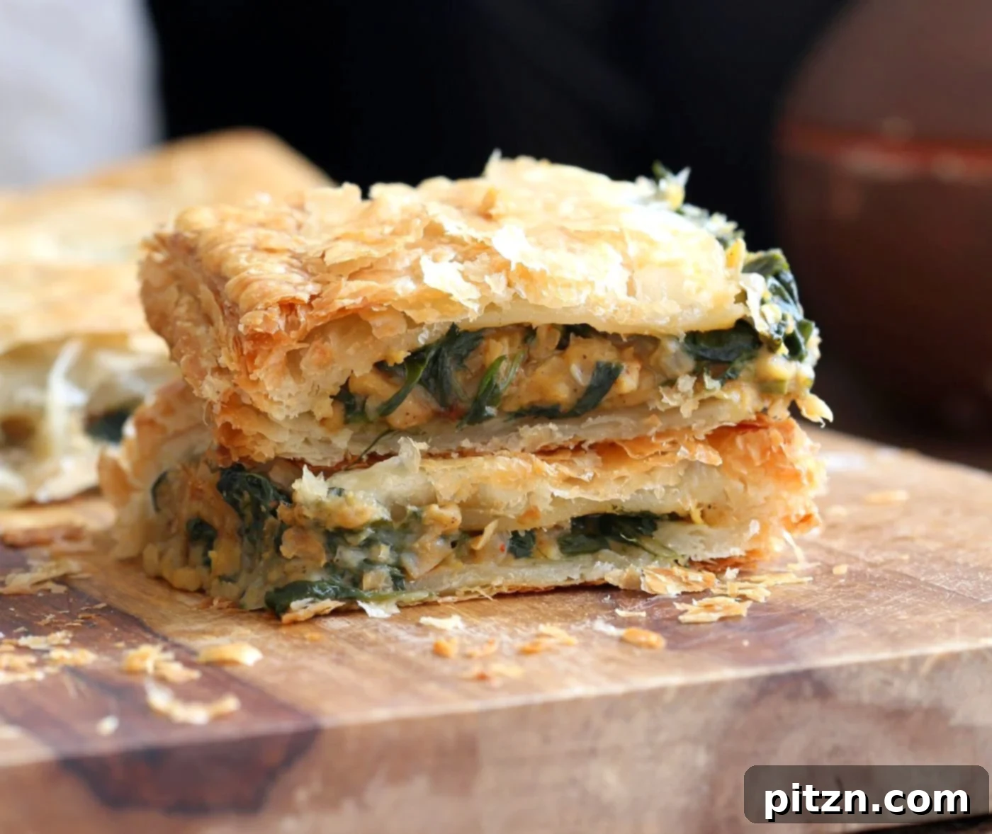 Spicy Ethiopian Chickpea Spinach Tart 10 A large, golden-brown Chickpea Spinach Pie, ready to be sliced and served.