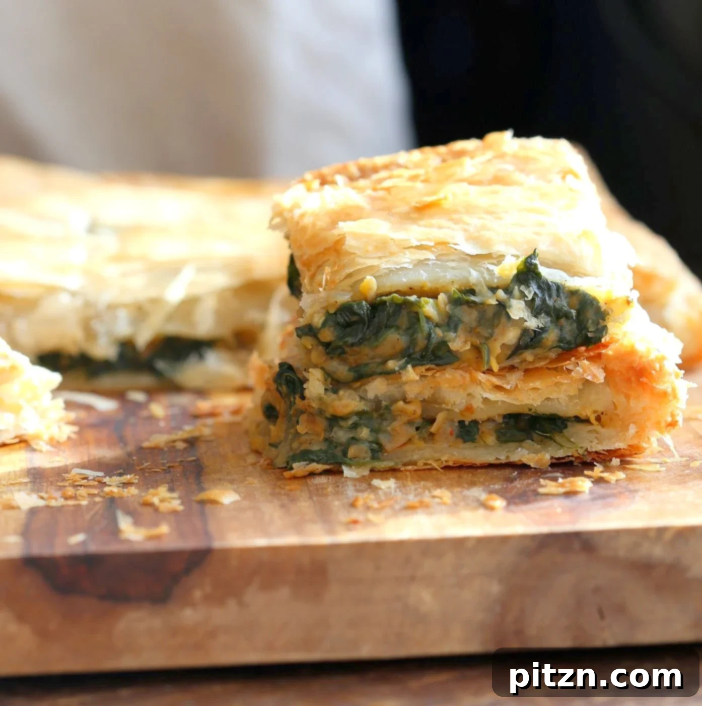 Spicy Ethiopian Chickpea Spinach Tart 3 Close-up of golden-brown Chickpea Spinach Pie, showcasing its flaky crust.