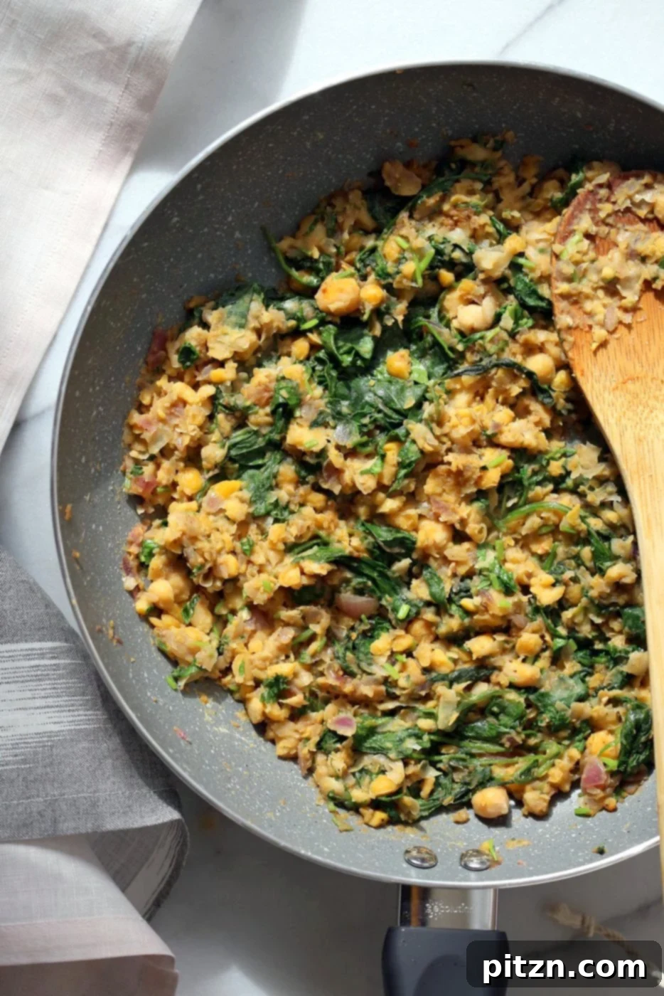 Spicy Ethiopian Chickpea Spinach Tart 4 Ingredients for Chickpea Spinach Pie being cooked in a skillet.