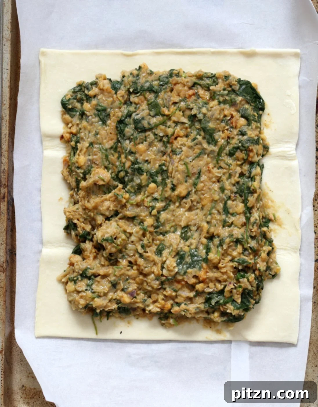 Spicy Ethiopian Chickpea Spinach Tart 5 Chickpea Spinach Filling spread on puff pastry, ready for baking.