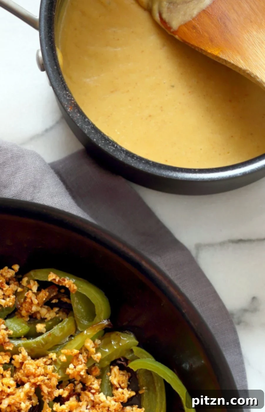 A bowl of creamy vegan queso dip, garnished with fresh cilantro and pickled jalapenos, ready to serve.