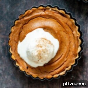 Mini vegan and gluten-free pumpkin pies, naturally sweetened with dates, perfect for Thanksgiving.
