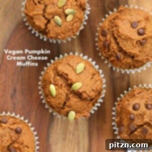 One-bowl vegan pumpkin cream cheese muffins, garnished with pumpkin seeds.