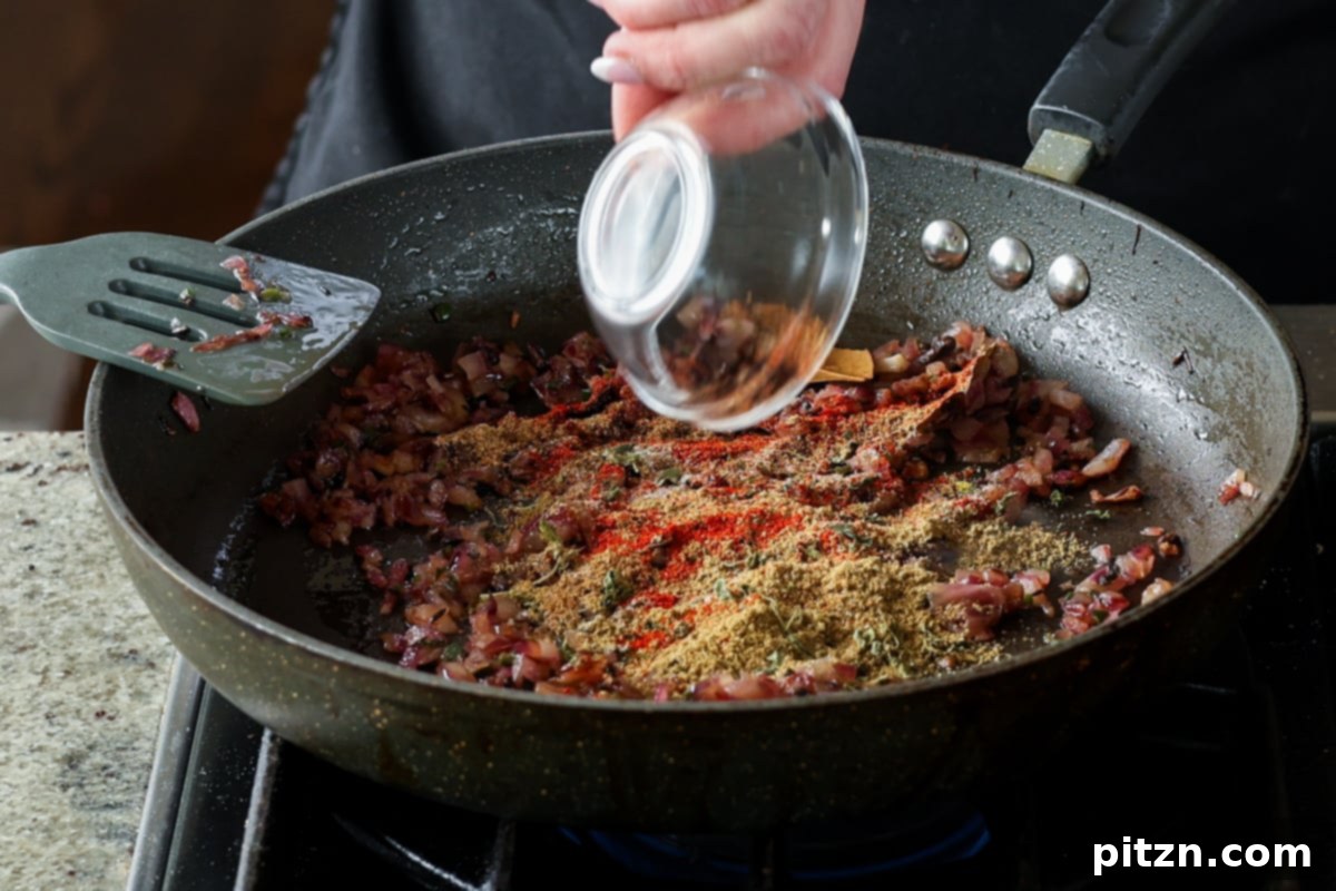 Flavorful Tikki Chole Potato Quinoa Patties and Chickpea Curry 22 adding ground spices to the pan