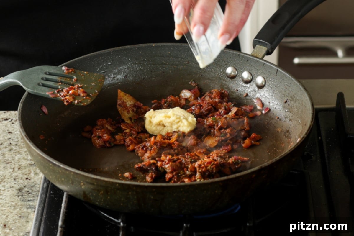 Flavorful Tikki Chole Potato Quinoa Patties and Chickpea Curry 23 adding ginger garlic paste to the pan