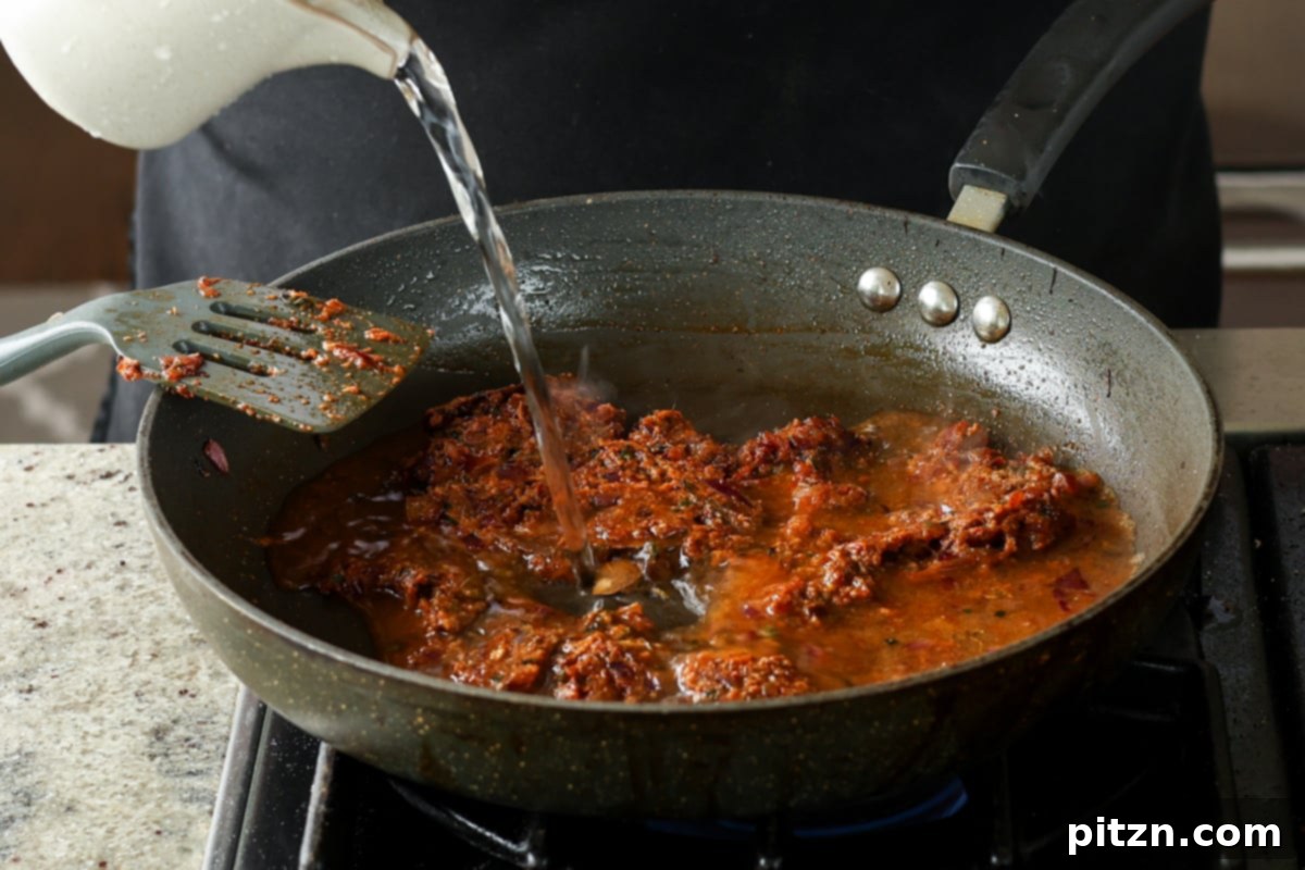 Flavorful Tikki Chole Potato Quinoa Patties and Chickpea Curry 25 adding water to the pan