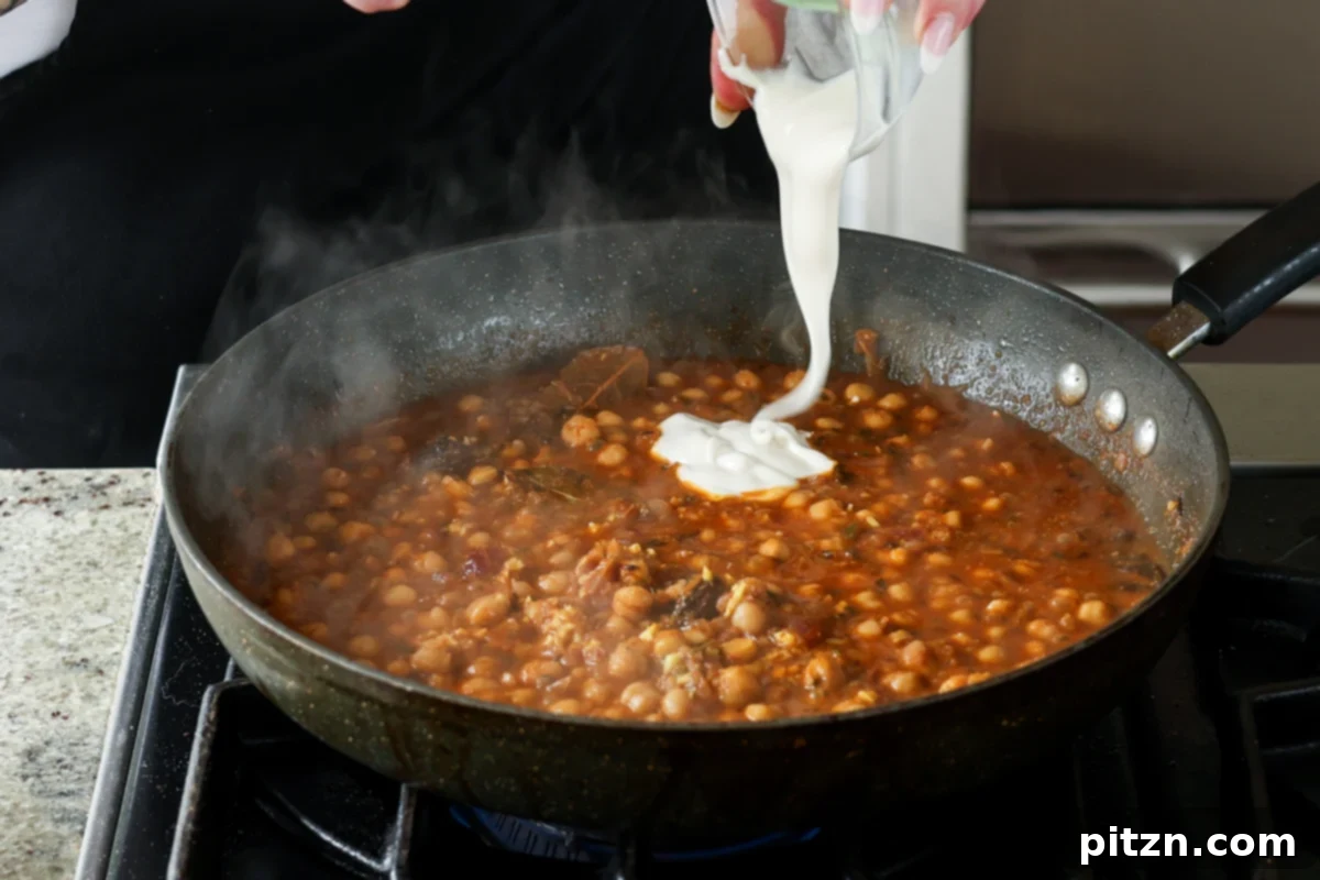 Flavorful Tikki Chole Potato Quinoa Patties and Chickpea Curry 28 adding non-dairy yogurt to the chole