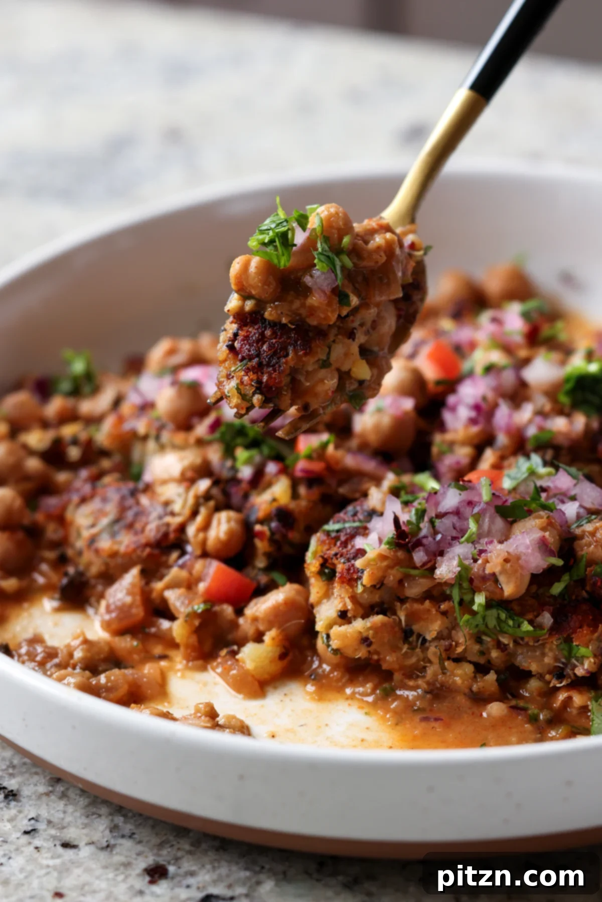 Flavorful Tikki Chole Potato Quinoa Patties and Chickpea Curry 6 fork taking a bite of tikki chole