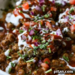 close-up of tikki chole in a bowl after adding toppings