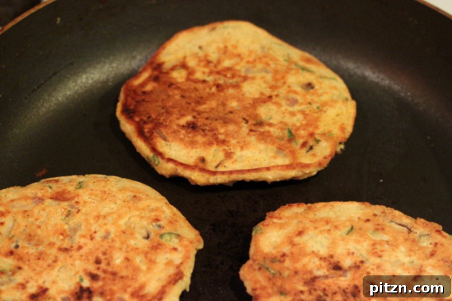 Flipped chickpea flour pancakes on a pan