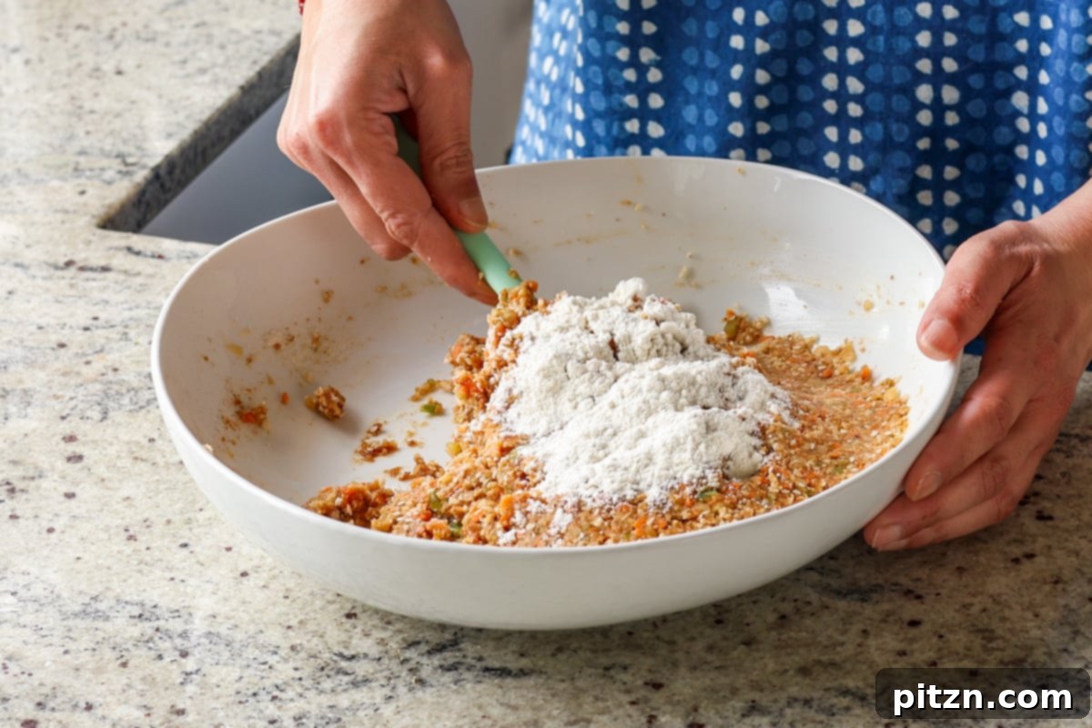 Adding all-purpose flour to the BBQ lentil burger mixture, helping to bind the patties and achieve the right consistency.