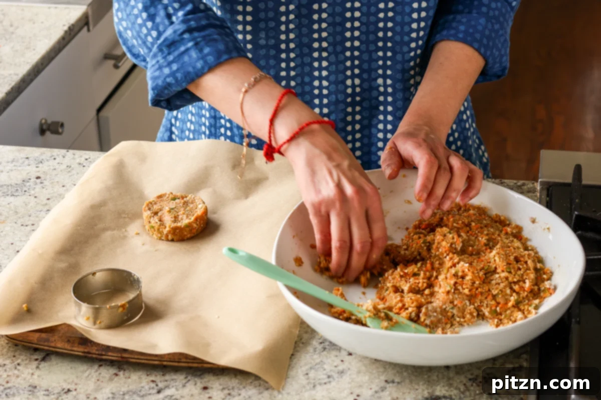 Hands carefully forming the BBQ lentil burger mixture into perfectly shaped patties.