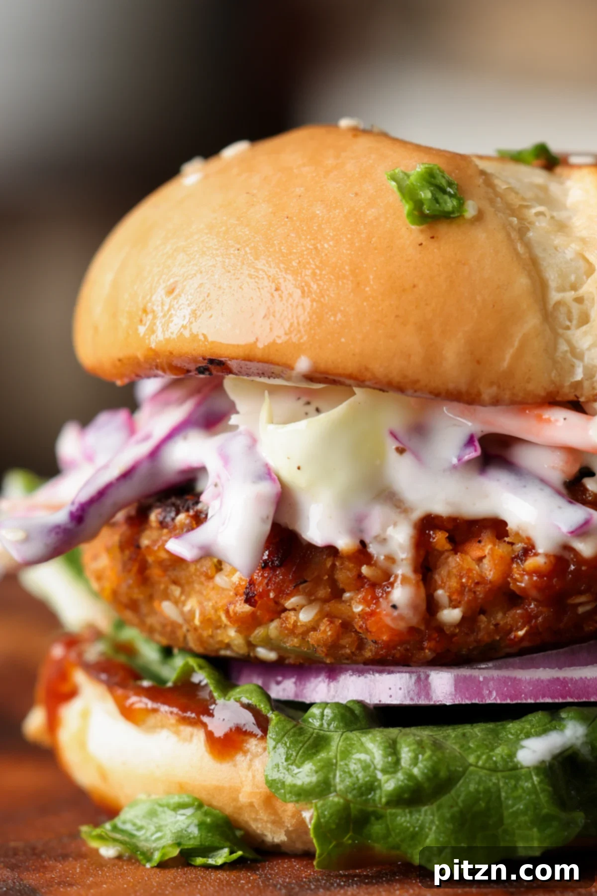Close-up view of a perfectly cooked BBQ lentil burger patty, showcasing its rich texture and caramelized BBQ glaze. A truly satisfying vegan burger.