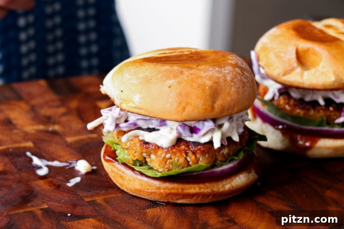 A fully assembled BBQ lentil burger in a bun, topped with fresh coleslaw, ready to be enjoyed as a hearty vegan meal.