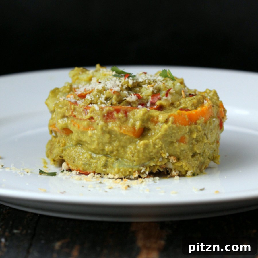 side view of vegan sweet potato spinach alfredo bake on a white plate, ready to be eaten