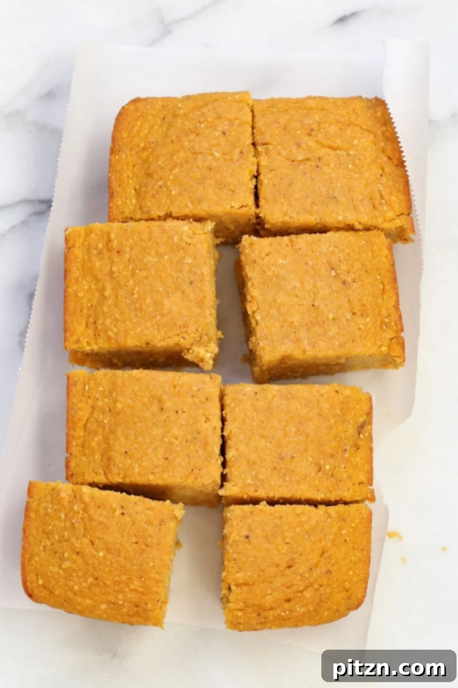 Close-up of a slice of Vegan Pumpkin Cornbread, showing its moist texture and golden color. Delicious with vegan butter or maple syrup. #VeganBaking #SoyFree