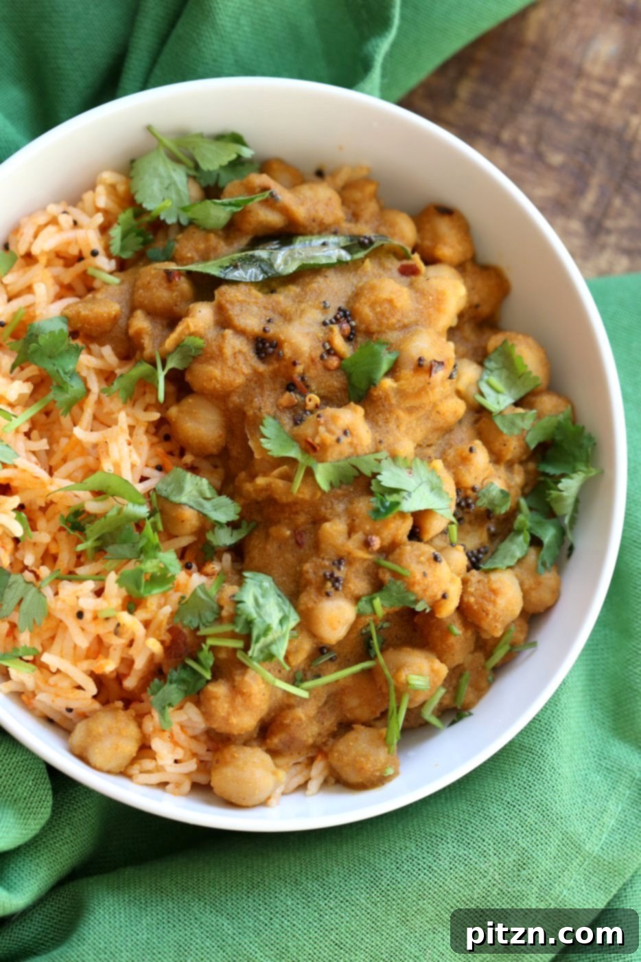 Chana Gassi /Ghassi - A final artful shot of the Mangalorean Coconut Onion sauce with Chickpeas, garnished with fresh herbs and a slice of lemon, presented beautifully as a regional Indian curry that is Vegan, Gluten-free, Soy-free, Nut-free.