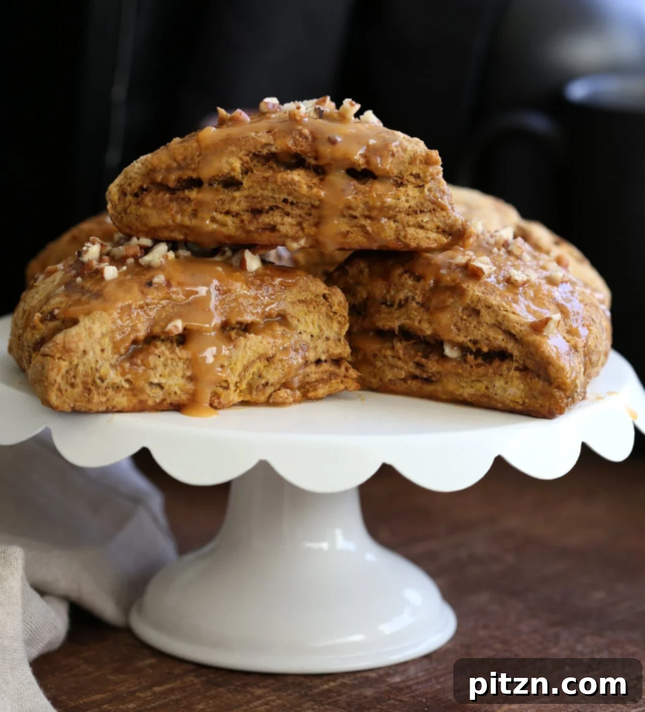 Close-up of golden brown vegan pumpkin scones cooling on a rack, awaiting glaze